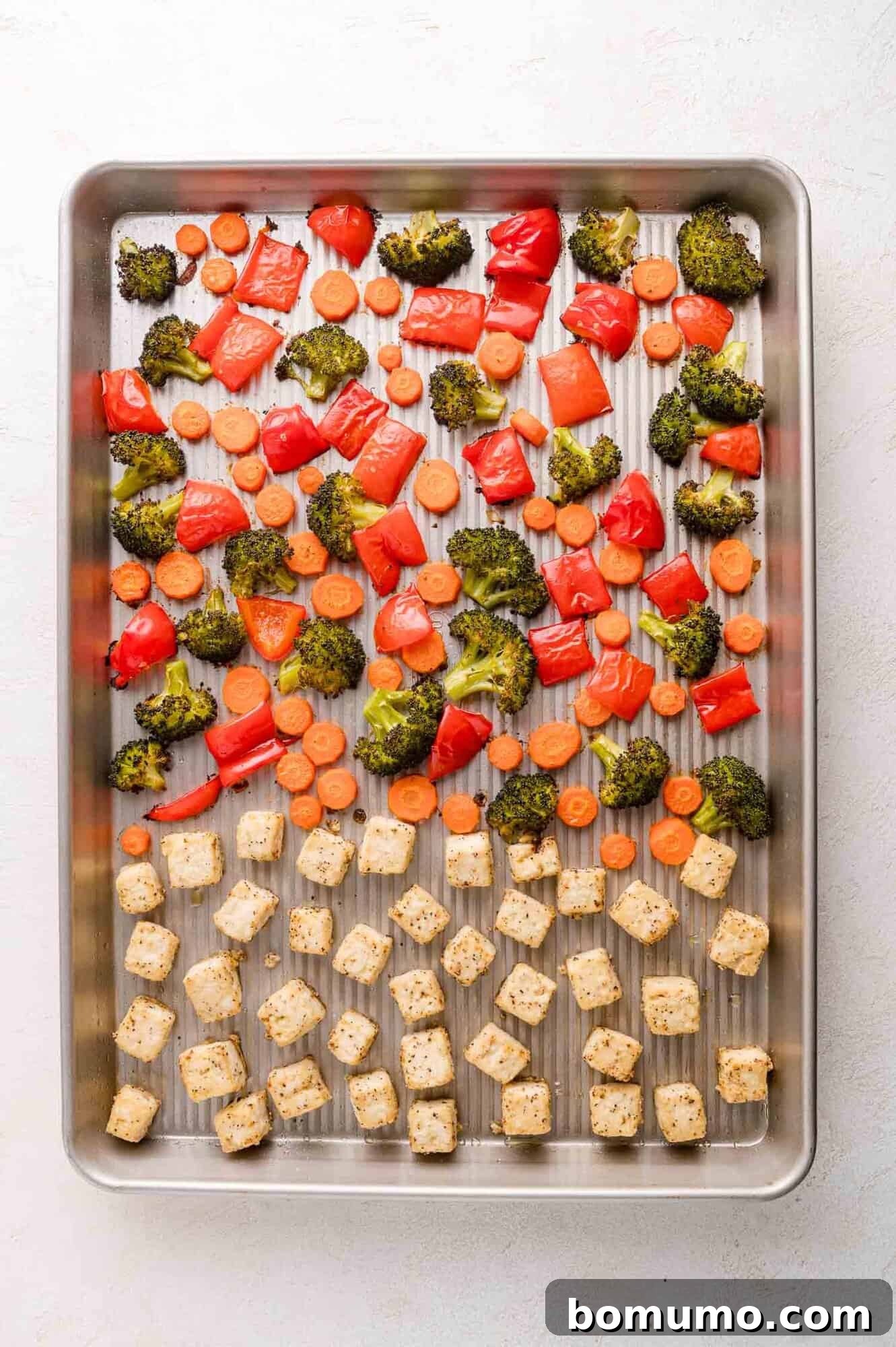 Roasted tofu and vegetables on a baking sheet