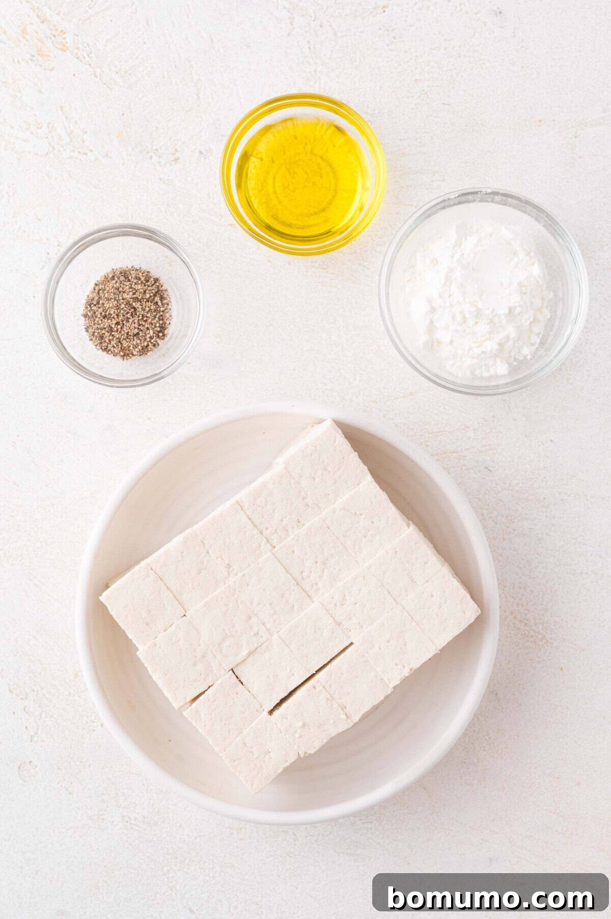 Cubed tofu, oil, cornstarch, and black pepper