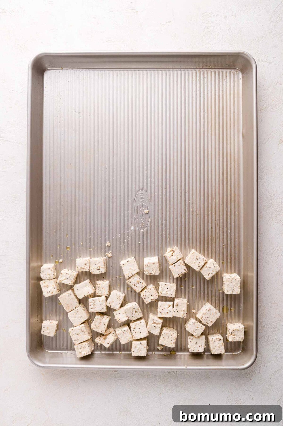 Seasoned tofu spread on a baking sheet
