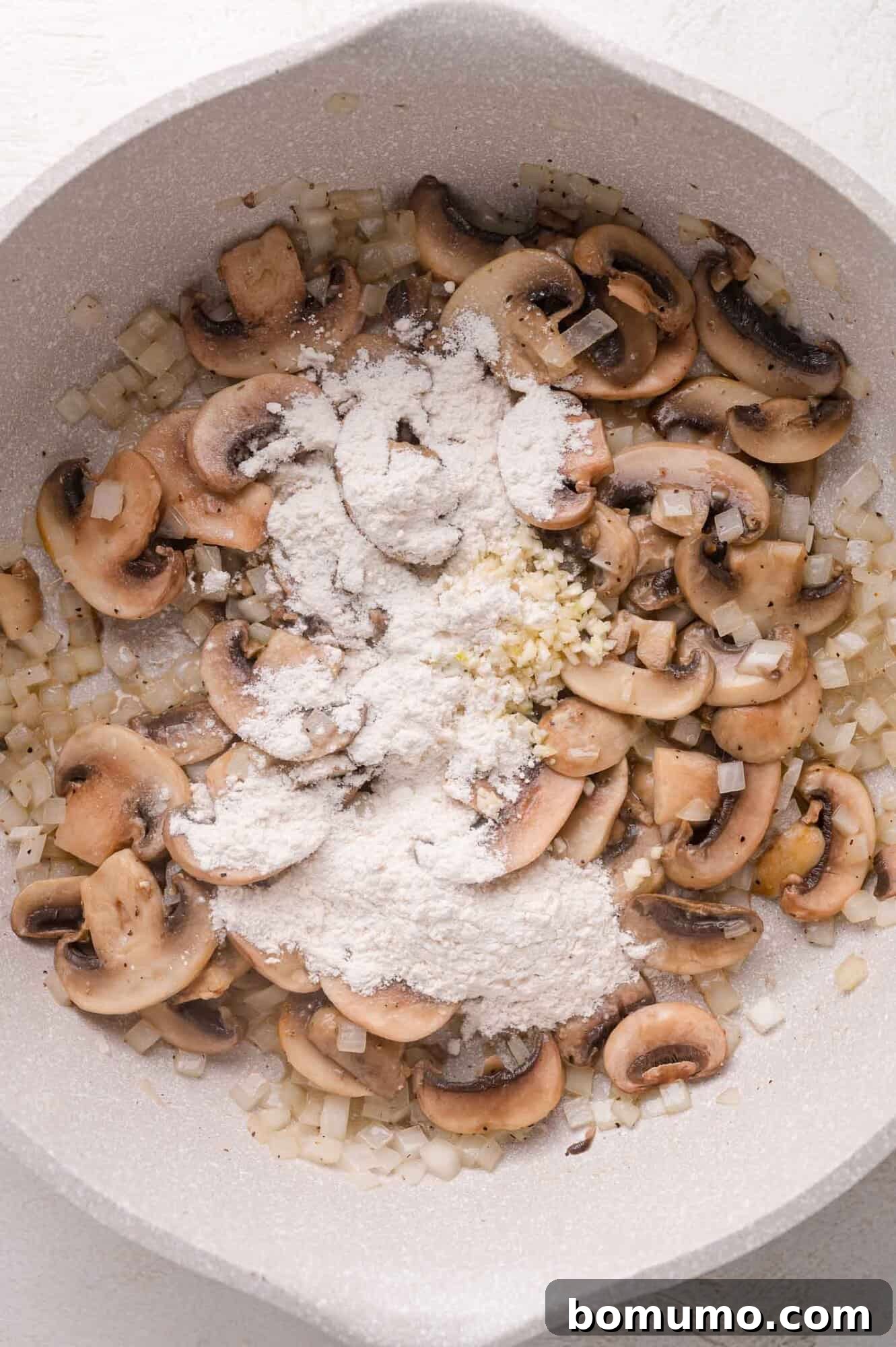 Adding garlic and flour