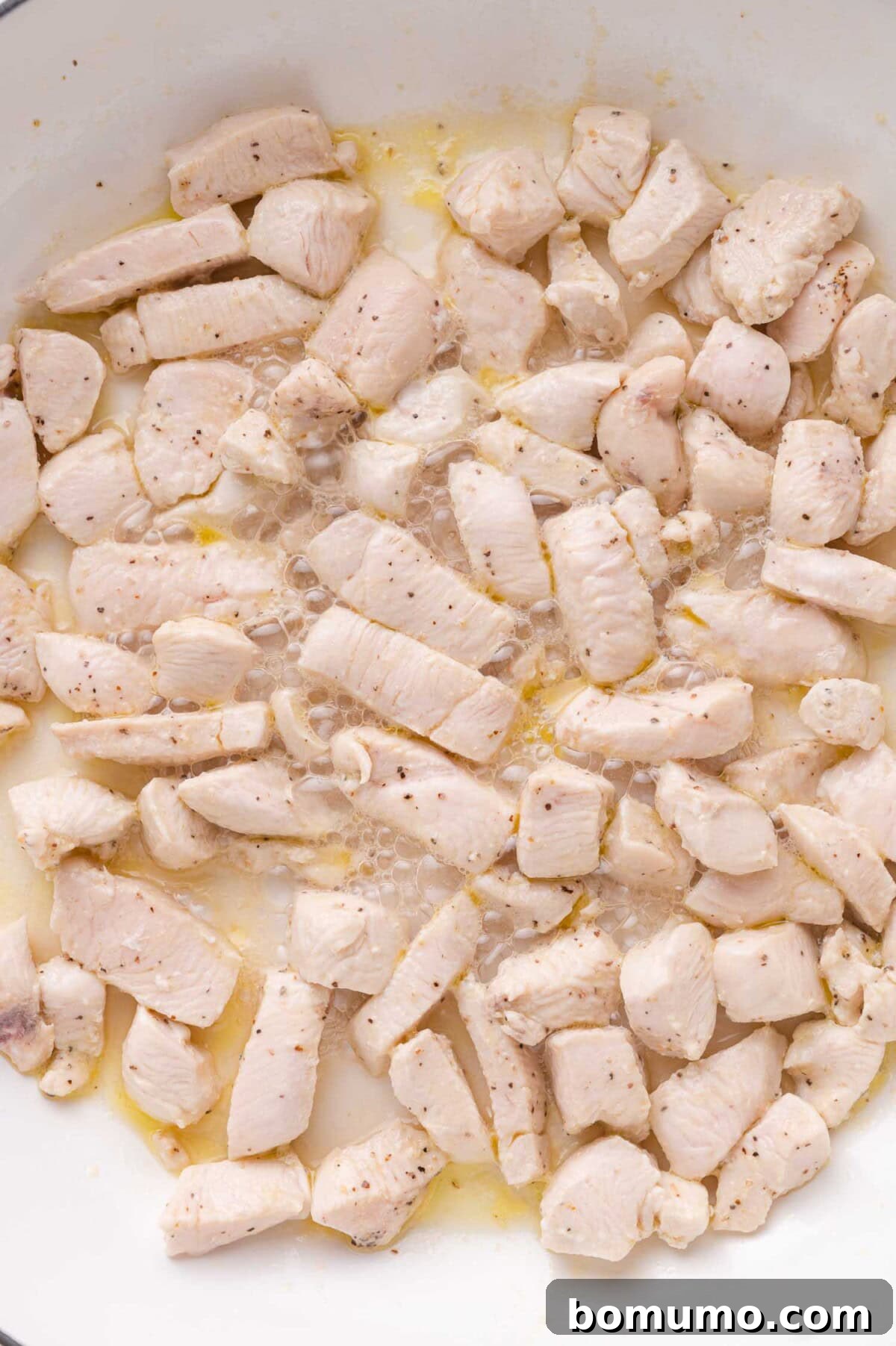Chicken cooking in skillet