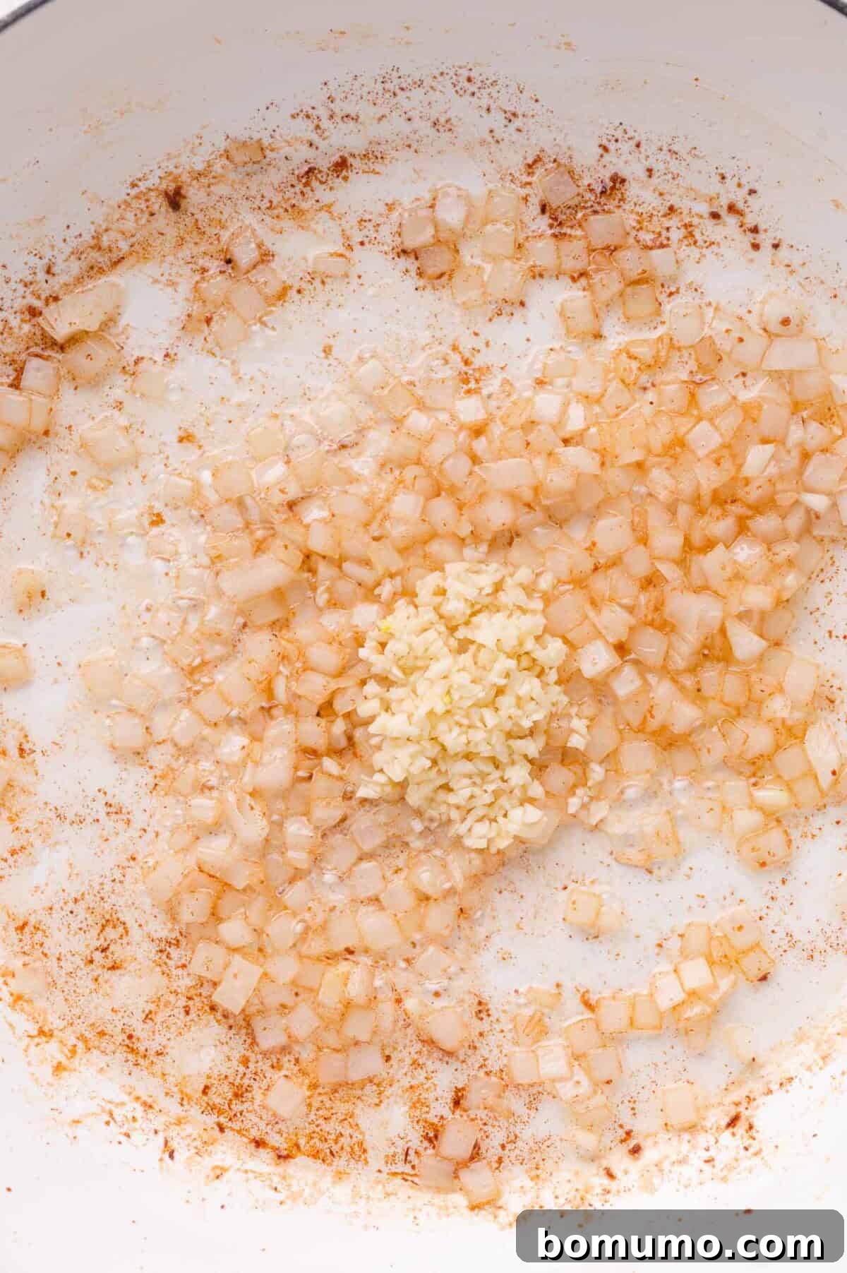 Garlic being sautéed in pan