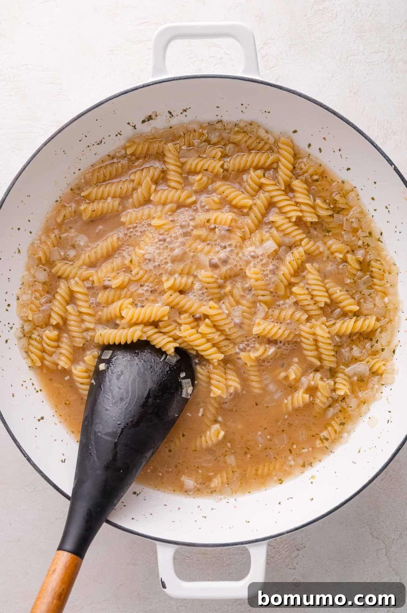 Pasta being cooked in a white pot
