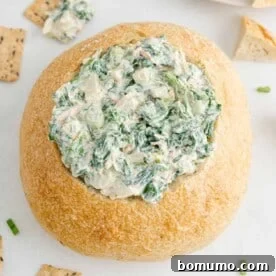 Classic Spinach Dip served in a bread bowl.