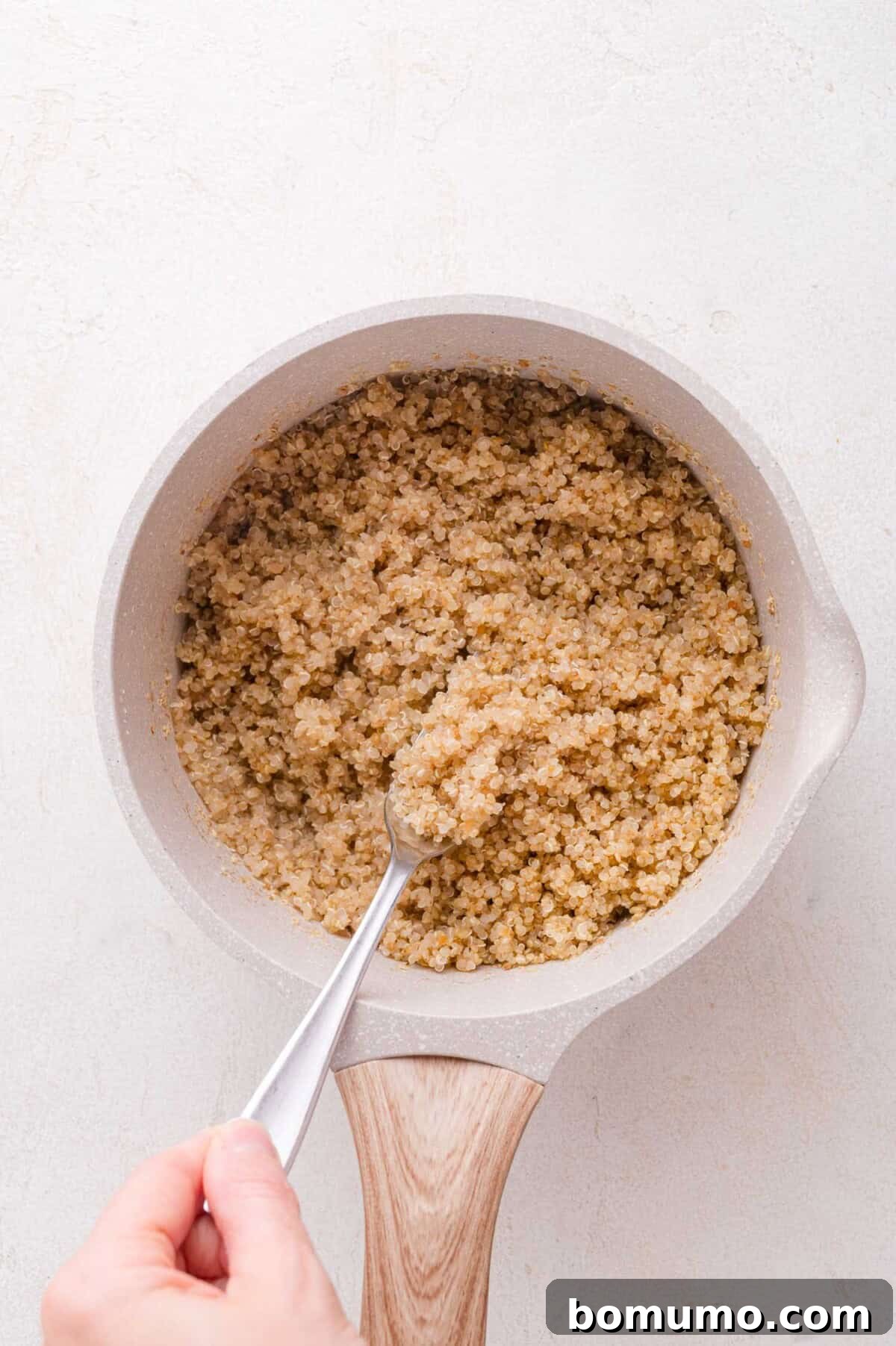 Fluffing cooked quinoa with a fork