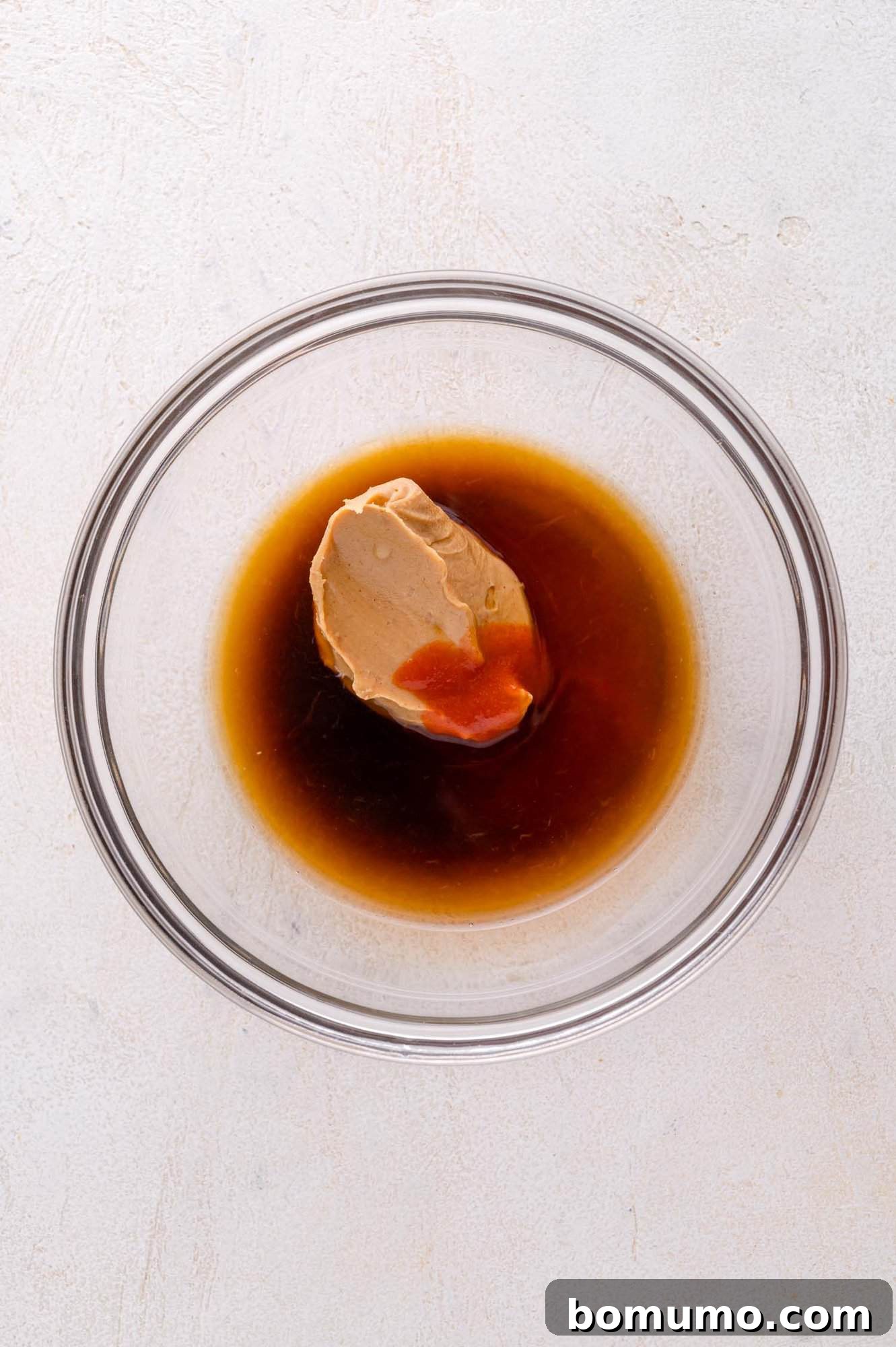 Mixing peanut butter and soy sauce for the dressing