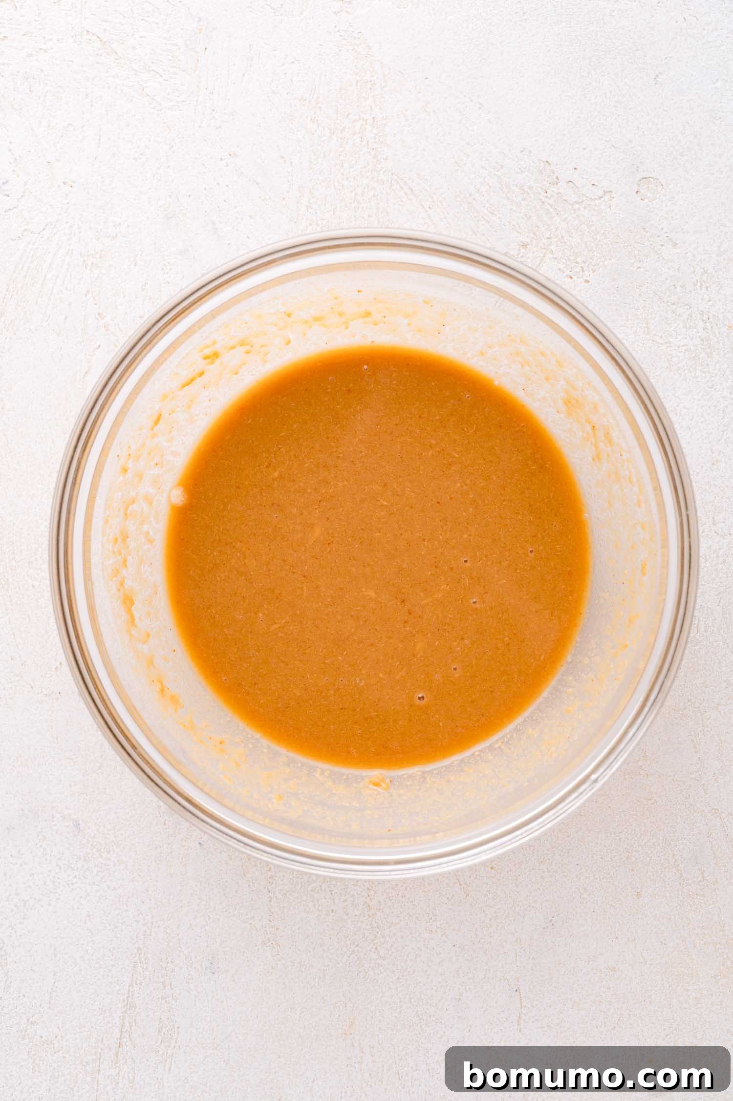 Smooth peanut dressing in a glass bowl