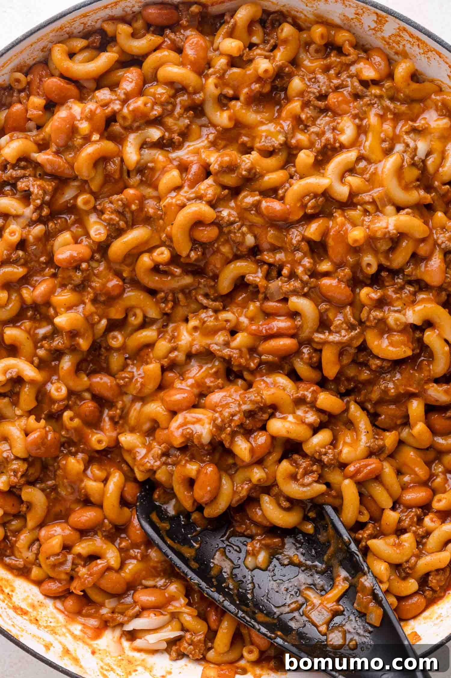 Chili mac with spoon.