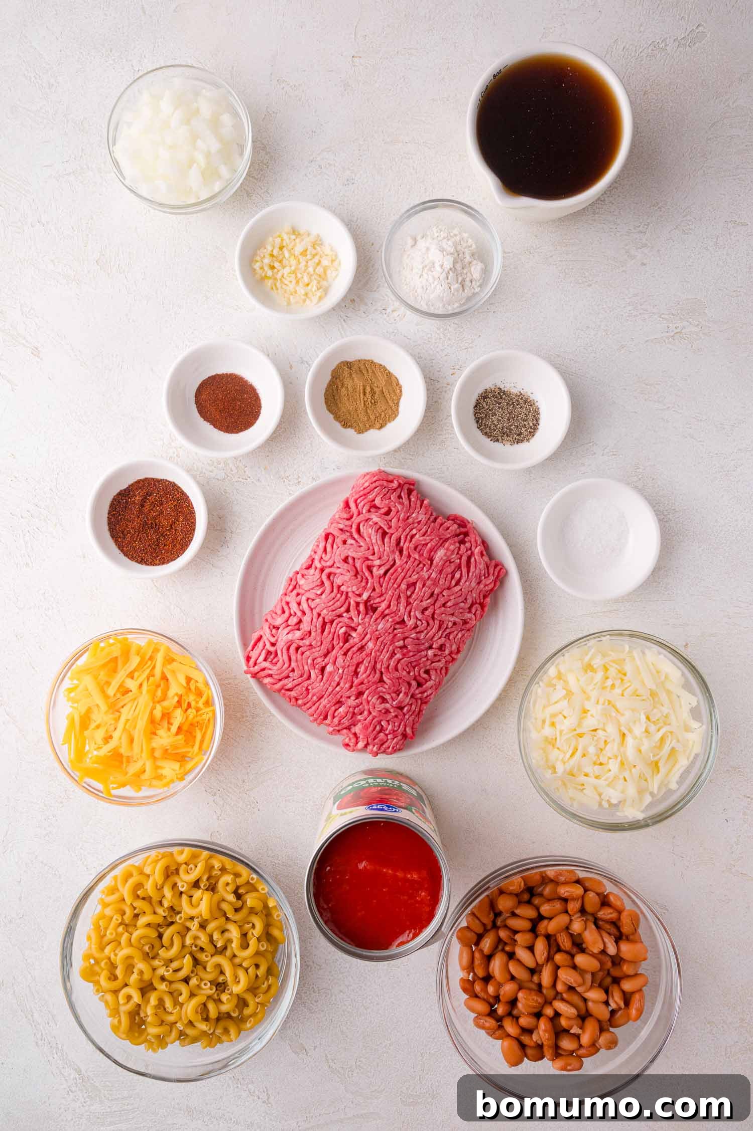 Chili mac ingredients in bowls.