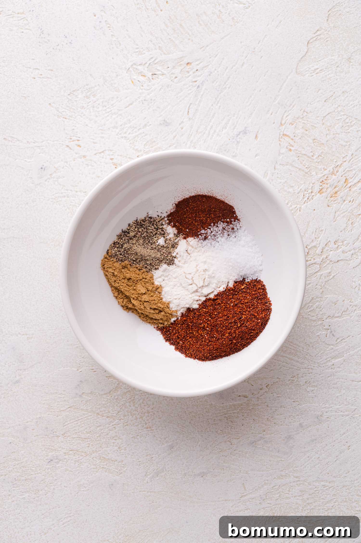 Ground spices and seasonings in a bowl.