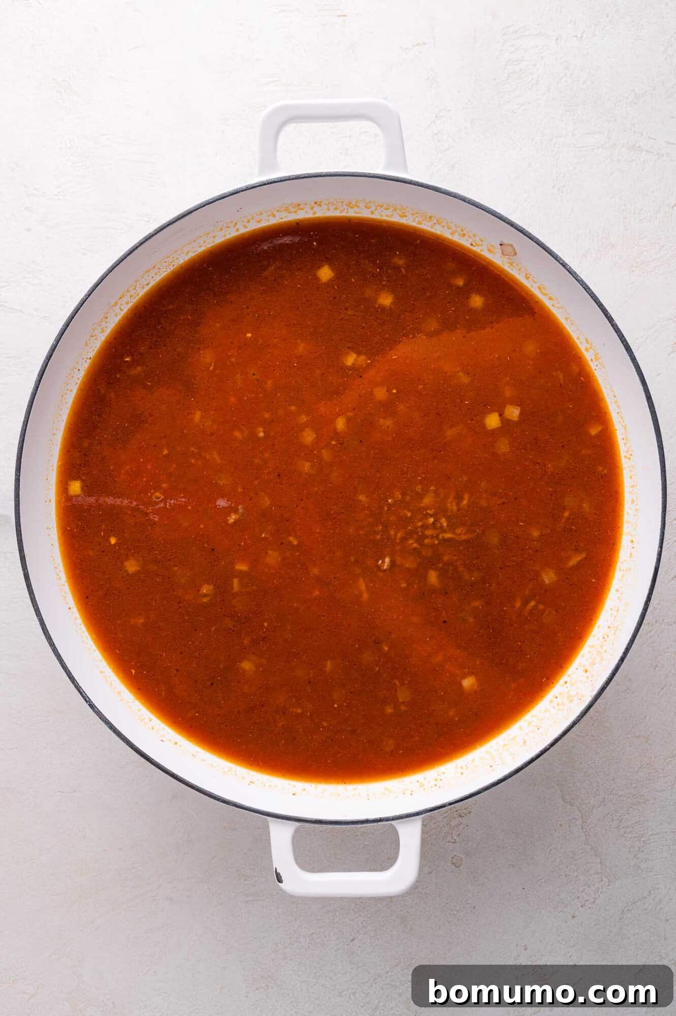 Broth and vegetables in a pot.