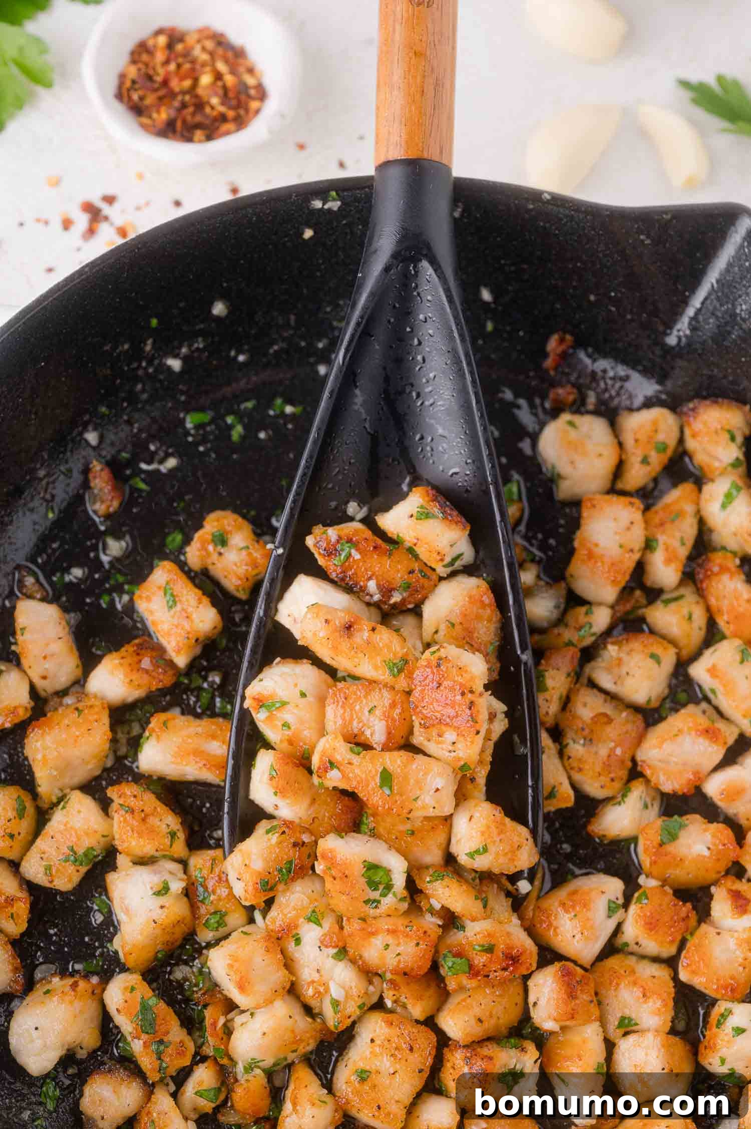 Seasoned chicken breast are cooked and browned in a skillet.