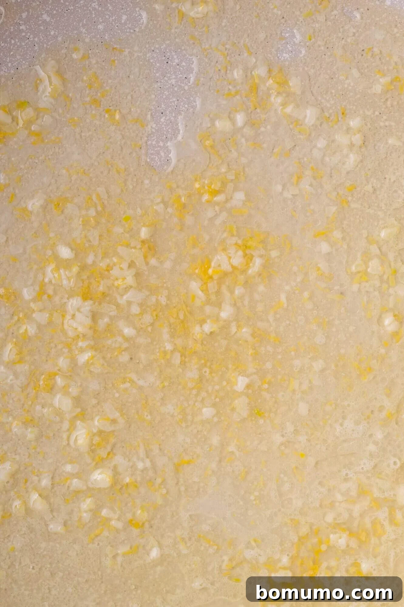 Golden Lemon Butter Cod 9 Lemon juice and zest being added to the garlic butter sauce in the pan.