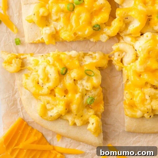 Mac and cheese pizza cut into squares.