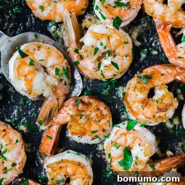 Garlic Butter Shrimp Scampi with Lemon and Parsley 13 Lemon pepper shrimp in a black pan.